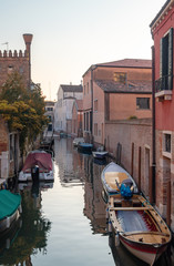 Venice, Italy. Narrow canal with moored boats