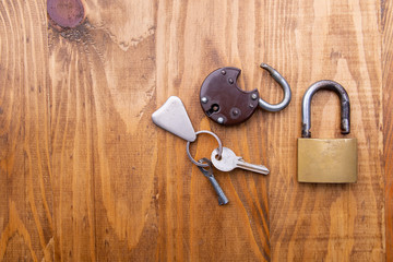 Old padlock and key on a wooden background. Text space