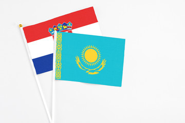 Kazakhstan and Croatia stick flags on white background. High quality fabric, miniature national flag. Peaceful global concept.White floor for copy space.