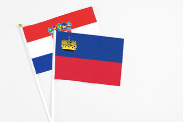 Liechtenstein and Croatia stick flags on white background. High quality fabric, miniature national flag. Peaceful global concept.White floor for copy space.