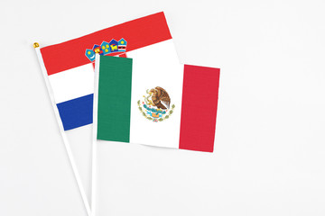 Mexico and Croatia stick flags on white background. High quality fabric, miniature national flag. Peaceful global concept.White floor for copy space.