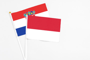 Monaco and Croatia stick flags on white background. High quality fabric, miniature national flag. Peaceful global concept.White floor for copy space.