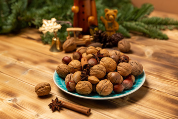 Stilllife photography of a bowl with lots of nuts. On a table with christmas decoration