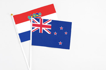 Fototapeta premium New Zealand and Croatia stick flags on white background. High quality fabric, miniature national flag. Peaceful global concept.White floor for copy space.