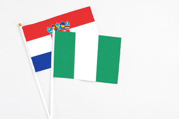 Nigeria and Croatia stick flags on white background. High quality fabric, miniature national flag. Peaceful global concept.White floor for copy space.