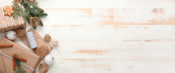 Composition with beautiful Christmas gift boxes on white wooden background with space for text