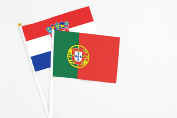 Portugal and Croatia stick flags on white background. High quality fabric, miniature national flag. Peaceful global concept.White floor for copy space.
