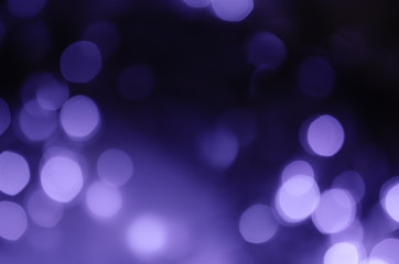 Abstract bokeh of purple lights on a dark background