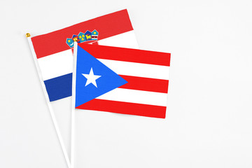Puerto Rico and Croatia stick flags on white background. High quality fabric, miniature national flag. Peaceful global concept.White floor for copy space.