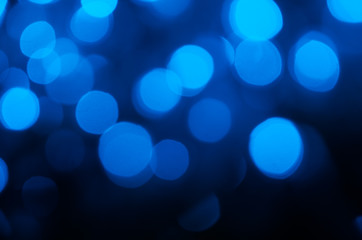 Abstract pattern of blue bokeh garland lights on a dark background