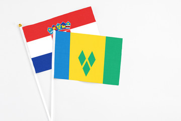 Saint Vincent And The Grenadines and Croatia stick flags on white background. High quality fabric, miniature national flag. Peaceful global concept.White floor for copy space.