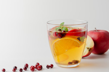 Spiced apple mocktail with mint and cinnamon. White background