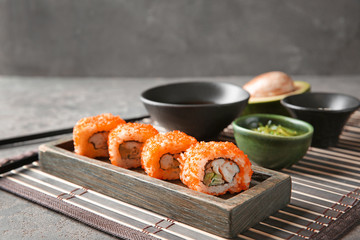 Tasty sushi rolls on table