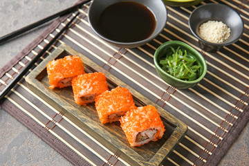 Tasty sushi rolls on table