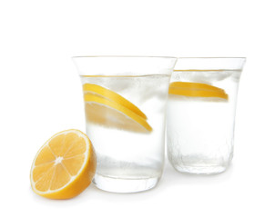 Glasses of fresh lemonade on white background