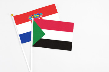 Sudan and Croatia stick flags on white background. High quality fabric, miniature national flag. Peaceful global concept.White floor for copy space.