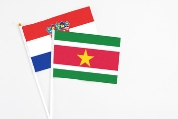 Suriname and Croatia stick flags on white background. High quality fabric, miniature national flag. Peaceful global concept.White floor for copy space.