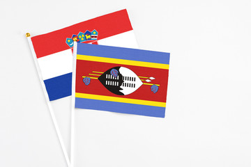 Swaziland and Croatia stick flags on white background. High quality fabric, miniature national flag. Peaceful global concept.White floor for copy space.