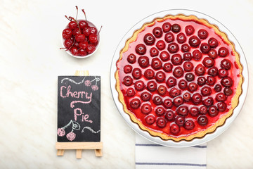 Tasty cherry pie on table