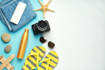 Composition with beach accessories on color background