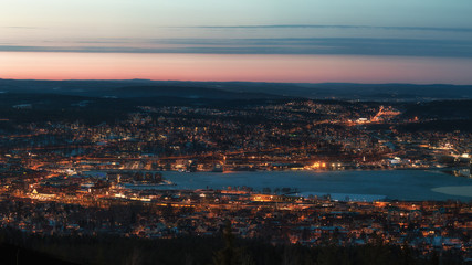 Panorama over the city Sundsvall during dusklwith mountains and valleys in the backgound