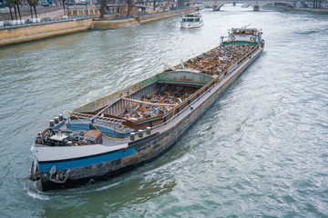 Fototapeta na wymiar Garbage ship with scrap metal in river