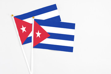 Cuba and Cuba stick flags on white background. High quality fabric, miniature national flag. Peaceful global concept.White floor for copy space.