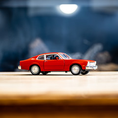 red model car on wood table
