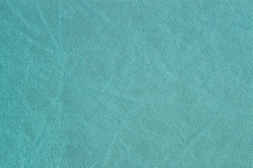 Rows of small loops, detal of knitted pattern, mint color, sackcloth or burlap with visible striped diagonal texture, for vivid background