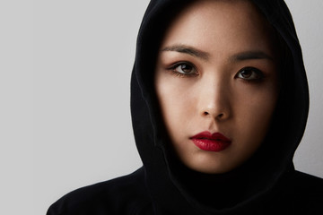 Young muslim asian woman posing on the white background. Isolated.