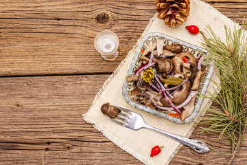 Pickled (fermented) mushrooms. Traditional New Year (Christmas) snack. Festive table cutlery setting