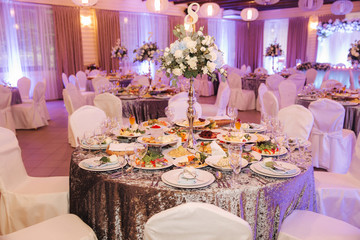 Element of decor in restaurant. Decoration on wedding. A chic tables in restaurant