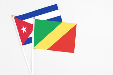 Republic Of The Congo and Cuba stick flags on white background. High quality fabric, miniature national flag. Peaceful global concept.White floor for copy space.