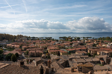 View of the roofs and Bolsena lake under blue sky, Viterbo, Italy. 