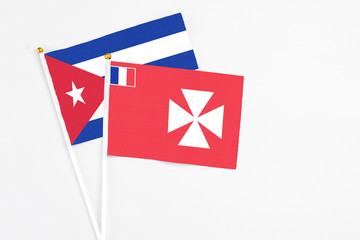 Wallis And Futuna and Cuba stick flags on white background. High quality fabric, miniature national...