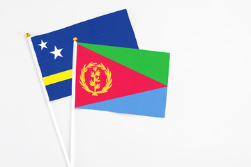 Eritrea and Curacao stick flags on white background. High quality fabric, miniature national flag. Peaceful global concept.White floor for copy space.