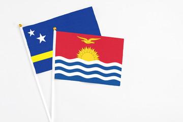 Kiribati and Curacao stick flags on white background. High quality fabric, miniature national flag. Peaceful global concept.White floor for copy space.