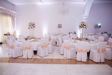 Decorated table for wedding celebration. Bright restaurand with a lot of windows