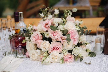 Floral decoration on the wedding ceremony by the restaurant. Pink and white color of rose. Elegant decor on charming wedding