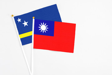 Taiwan and Curacao stick flags on white background. High quality fabric, miniature national flag. Peaceful global concept.White floor for copy space.