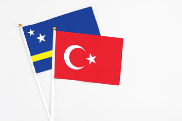 Turkey and Curacao stick flags on white background. High quality fabric, miniature national flag. Peaceful global concept.White floor for copy space.