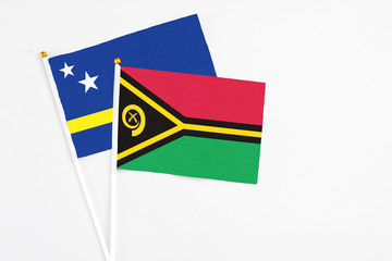 Vanuatu and Curacao stick flags on white background. High quality fabric, miniature national flag. Peaceful global concept.White floor for copy space.