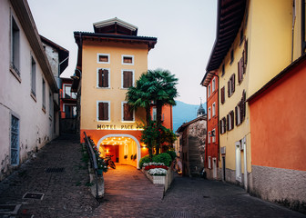 Cityscape with hotel building in Arco town center near Garda lake of Trentino of Italy. Street with house architecture at Old city in Trento near Riva del Garda. Travel and tourism. Evening