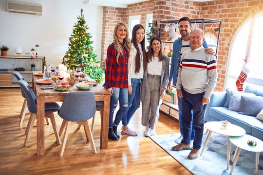 Beautiful family smiling happy and confident. Standing posing with tree celebrating Christmas at home