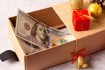 Christmas gifts in craft paper on a gray background with decorations.