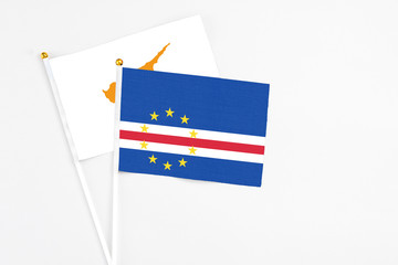 Cape Verde and Cyprus stick flags on white background. High quality fabric, miniature national flag. Peaceful global concept.White floor for copy space.