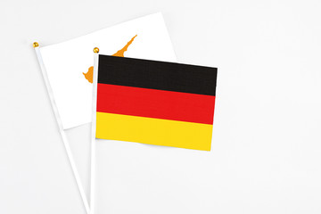 Germany and Cyprus stick flags on white background. High quality fabric, miniature national flag. Peaceful global concept.White floor for copy space.