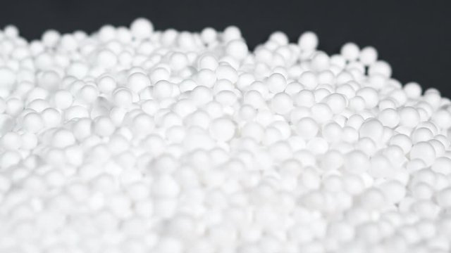 White round polystyrene packaging material in pan shot, modern foam bead ball decoration cause global warming from chemical waste