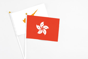Hong Kong and Cyprus stick flags on white background. High quality fabric, miniature national flag. Peaceful global concept.White floor for copy space.