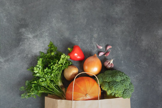 Shopping Bag Paper Full Of Fresh Organic Vegetables On Dark Table. Zero Waste Use Less Plastic Concept. Food Concept. Food Background. Healthy Eating Cooking Concept. No Plastic. Clever Consuming.